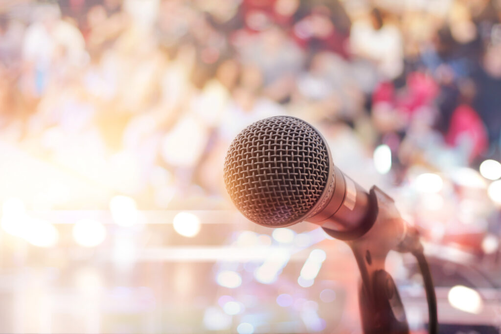 Microphone on stage in concert with people background